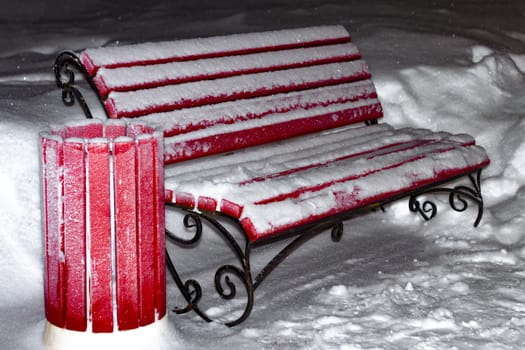 Red bench in winter. City of Siberia.