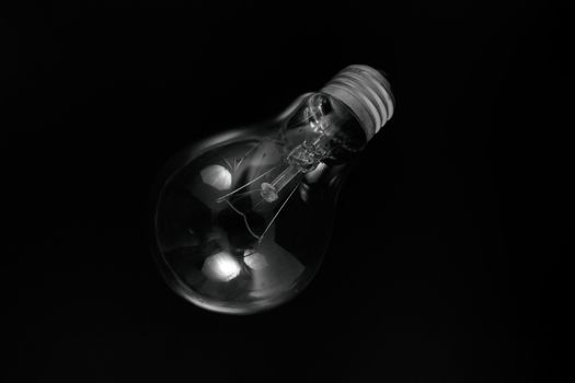 Incandescent light bulb on a black background