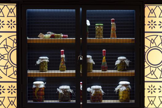 Bottles and cans in the window with lights.