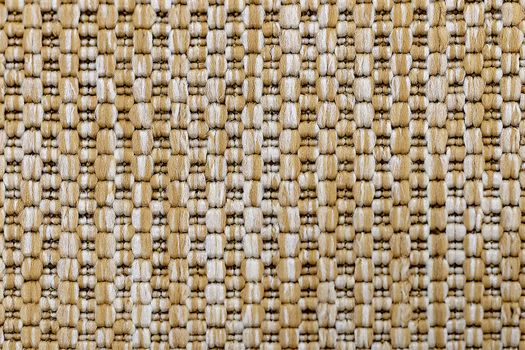 A knitted beige textile background. Fragment. View from above.