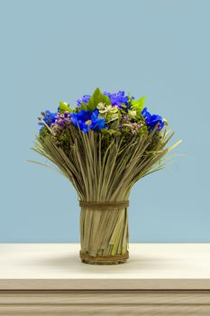 A bouquet of wildflowers tied with a rope on the dresser.