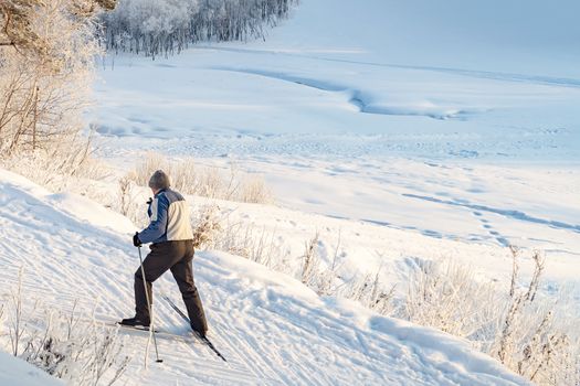 Skier man moves uphill. View from above. New