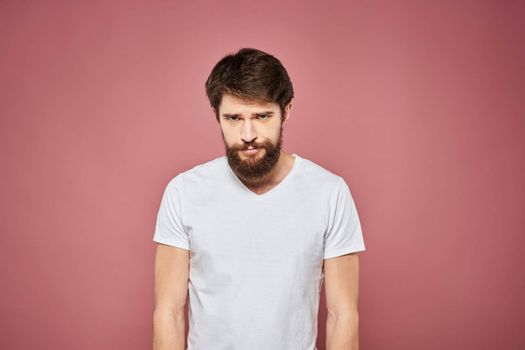 Man in white t-shirt emotions lifestyle facial expression cropped view pink background. High quality photo