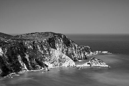 Rocky coast at Petani Bay on the island of Kefalonia in Greece, monochrome