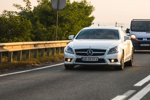 Traveling Mercedes car in motion on asphalt road, front view of car on street. Bucharest, Romania, 2020