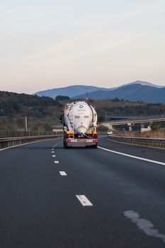 Loaded European truck in motion on asphalt road, transportation and delivery concept. Bucharest, Romania, 2020