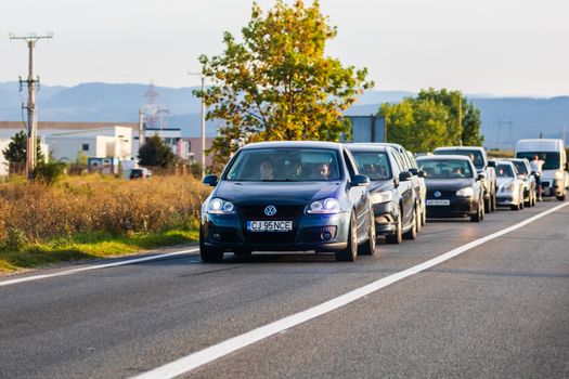 Traveling cars in motion on asphalt road, front view of cars in row on street. Bucharest, Romania, 2020