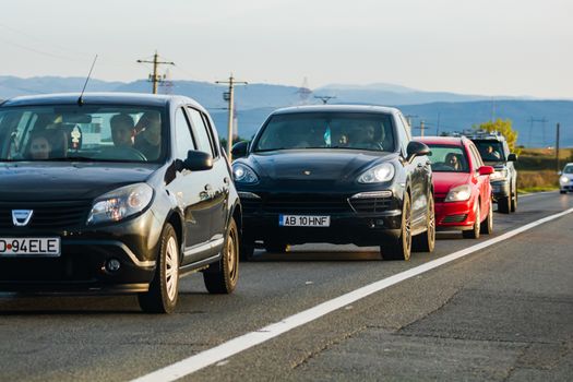 Traveling cars in motion on asphalt road, front view of cars in row on street. Bucharest, Romania, 2020