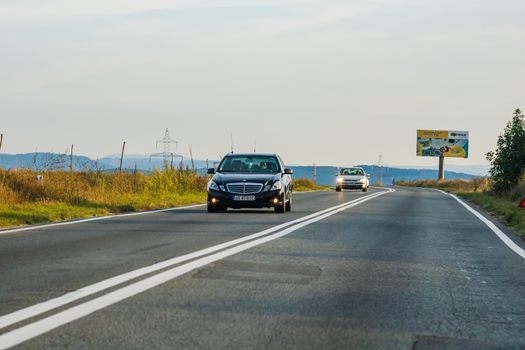 Traveling Mercedes car in motion on asphalt road, front view of car on street. Bucharest, Romania, 2020