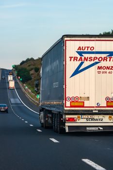 Side view of loaded European truck in motion on asphalt road, transportation and delivery concept. Detail on delivery truck. Bucharest, Romania, 2020