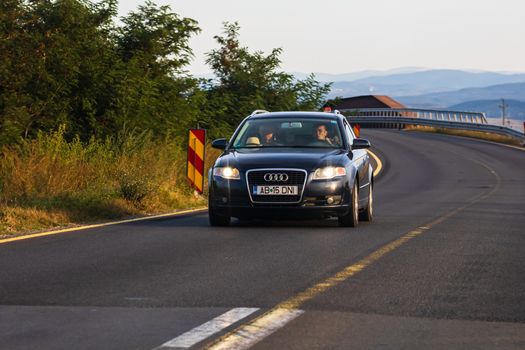 Traveling car in motion on asphalt road, front view of car on street. Bucharest, Romania, 2020