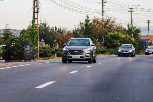 Traveling car in motion on asphalt road, front view of car on street. Bucharest, Romania, 2020