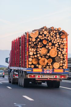 Side view of loaded European truck in motion on asphalt road, transportation and delivery concept. Detail on delivery truck. Bucharest, Romania, 2020