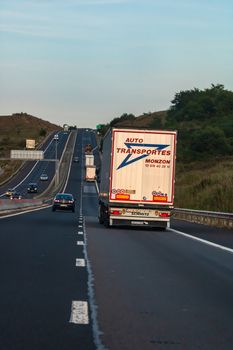 Loaded European truck in motion on asphalt road, transportation and delivery concept. Bucharest, Romania, 2020