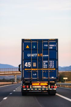 Loaded European truck in motion on asphalt road, transportation and delivery concept. Bucharest, Romania, 2020