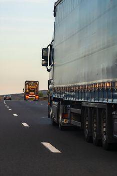 Side view of loaded European truck in motion on asphalt road, transportation and delivery concept. Detail on delivery truck. Bucharest, Romania, 2020