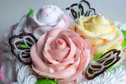 Sweet cream on the cake in the form of colorful roses.