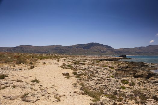 GRAMVOUSA - BALOS, THE CRETE ISLAND, GREECE - JUNE 4, 2019: People on the beach of Balos.