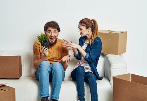 Married couple in new apartment moving boxes with joy things. High quality photo