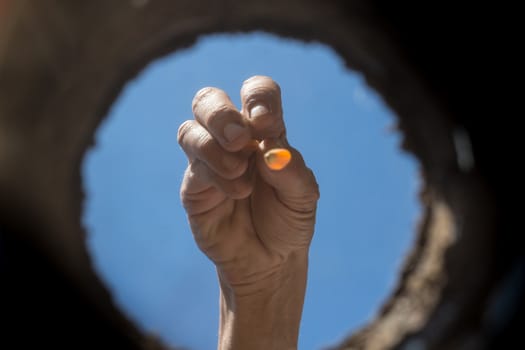 the hardworking hand that cultivates the garden seen from the inside of the earth