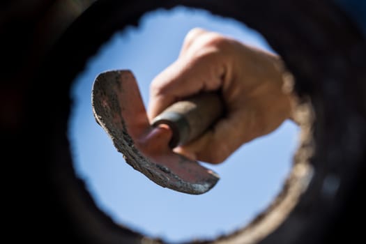 the hardworking hand that cultivates the garden seen from the inside of the earth