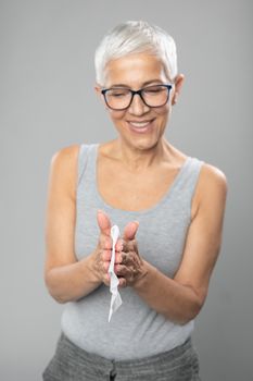 Senior woman cleaning hands with wet wipes, prevention of infectious diseases, covid19