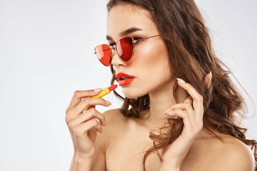 Fashionable brunette in sunglasses with makeup lipstick model. High quality photo