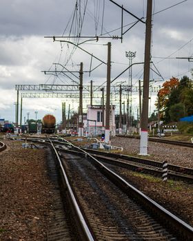 Railroad with rails and freight wagons and cisserines on them.