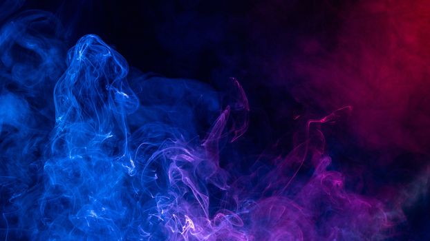 Conceptual image of colorful red and blue color smoke isolated on dark black background, Halloween concept design element.