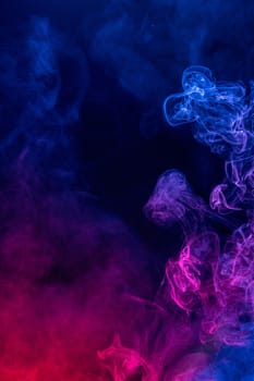 Conceptual image of colorful red and blue color smoke isolated on dark black background, Halloween concept design element.