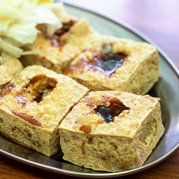 Deep fried stinky tofu, fermented bean curd with pickled cabbage vegetable, famous and delicious street food in Taiwan, lifestyle.