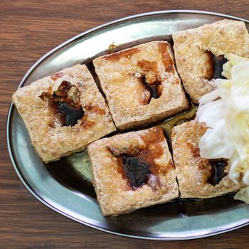 Deep fried stinky tofu, fermented bean curd with pickled cabbage vegetable, famous and delicious street food in Taiwan, lifestyle.