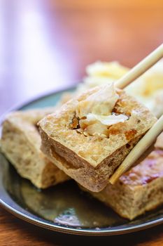 Deep fried stinky tofu, fermented bean curd with pickled cabbage vegetable, famous and delicious street food in Taiwan, lifestyle.