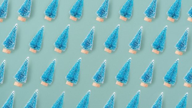 Top view of Christmas holiday pattern decoration ornament composition with Christmas tree objects flat lay with copy space isolated on green background.