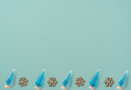 Top view of Christmas holiday pattern decoration ornament composition with Christmas tree objects flat lay with copy space isolated on green background.