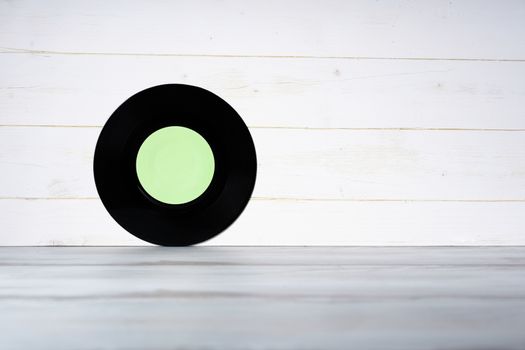 Vinyl record on wooden background,vintage style