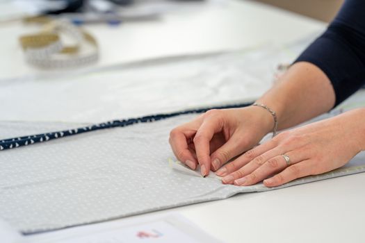 preparation of a template for making a dress in a tailor's shop