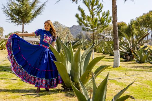 A gorgeous Hispanic Brunette model poses outdoors at a Mexican Hacienda