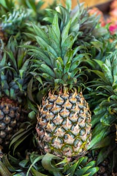 Freshly cut pineapples on the counter of a street food market.