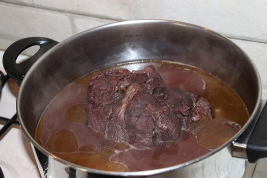 whole piece of beef is boiling in the pot