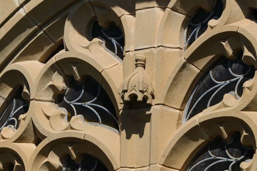 Ornate stone & lead glass window detail of a small village church building, Mossel Bay, South Africa