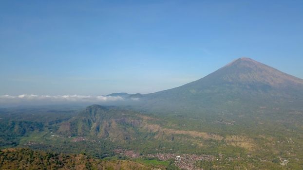 The volcano Gunung Agung dominating the horizon taken from Amed against a clear blue sky, a little fishing village located on the east coast of Bali, Indonesia.