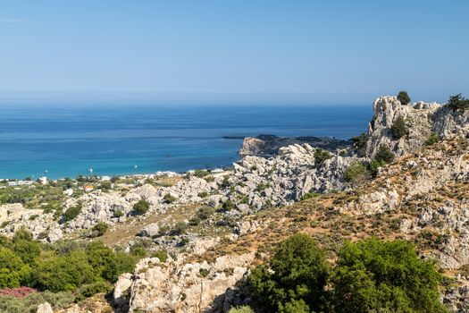 Scenic view at Stegna beach on Geek island Rhodes with rocks in the foreground and the mediterranean sea in the background on a sunny day in spring