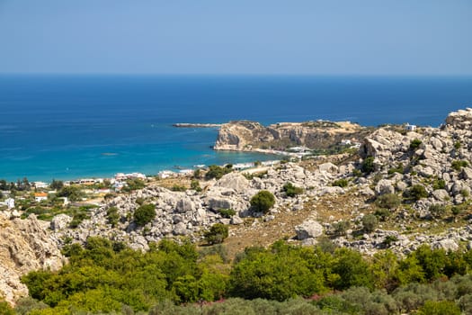 Scenic view at Stegna beach on Geek island Rhodes with rocks in the foreground and the mediterranean sea in the background on a sunny day in spring