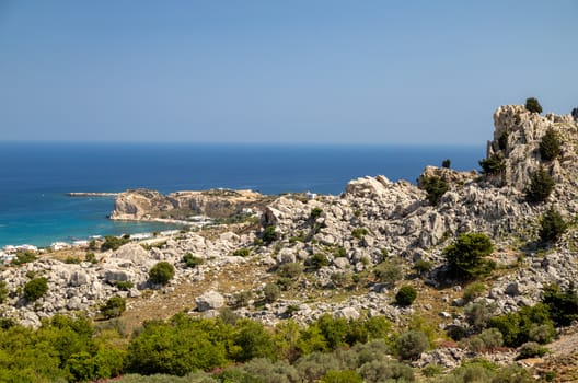 Scenic view at Stegna beach on Geek island Rhodes with rocks in the foreground and the mediterranean sea in the background on a sunny day in spring