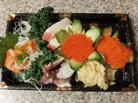 orange fish eggs and raw sushi in container