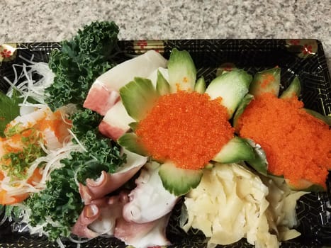 orange fish eggs and raw sushi in container