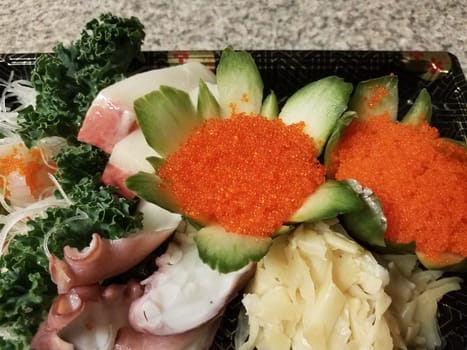 orange fish eggs and raw sushi in container