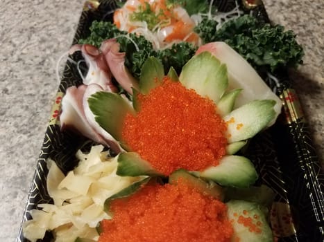 orange fish eggs and raw sushi in container