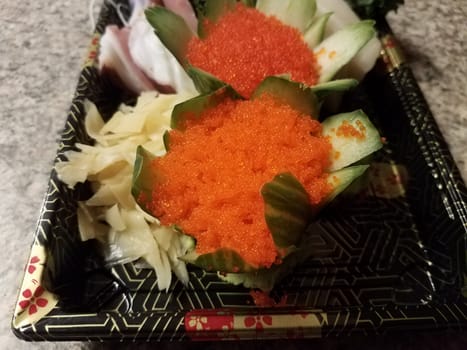 orange fish eggs and raw sushi in container